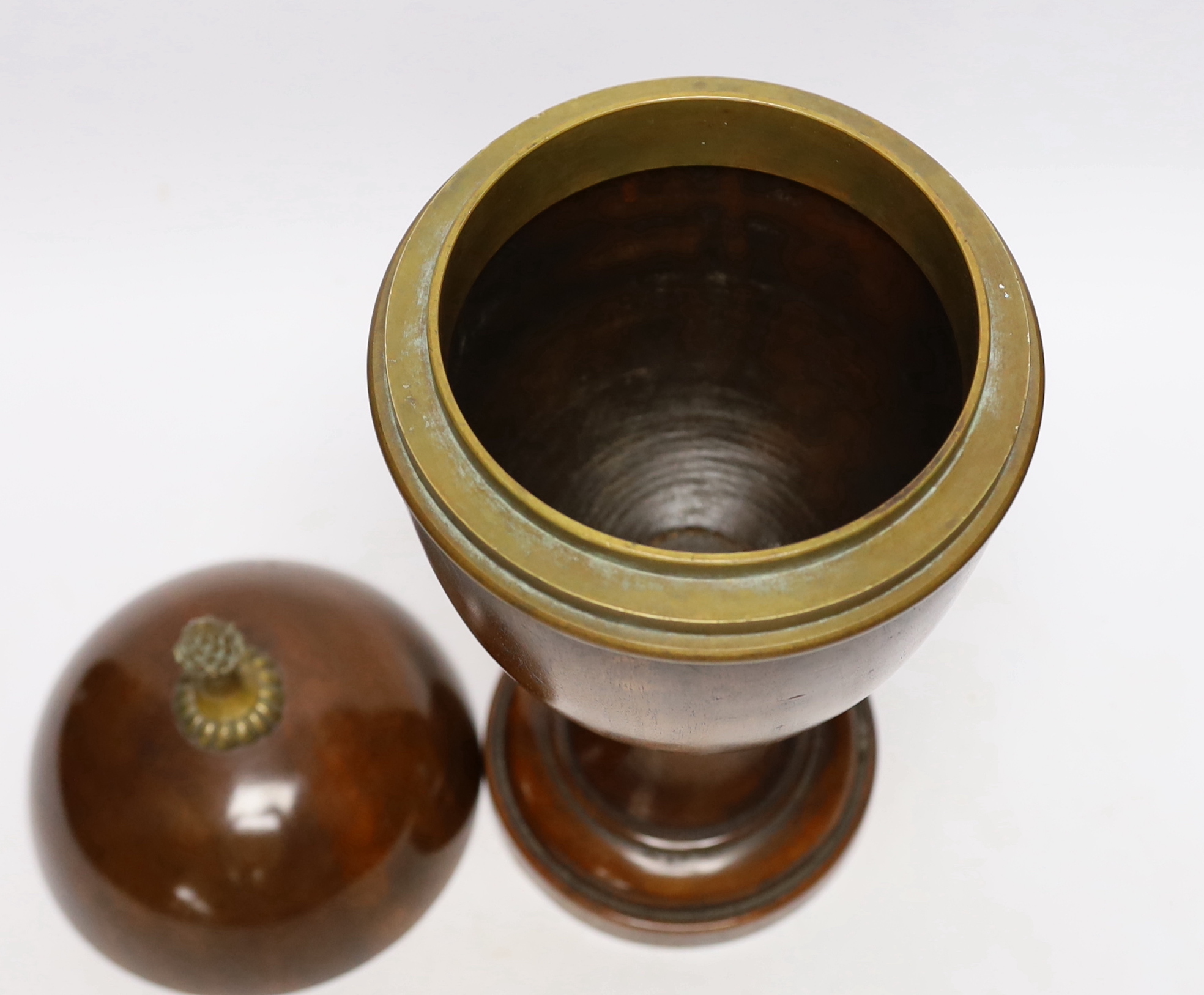 A turned wood urn and cover with brass acorn finial, 37cm high